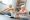 Senior man and woman doing yoga together indoors holding feet legs stretching smiling
